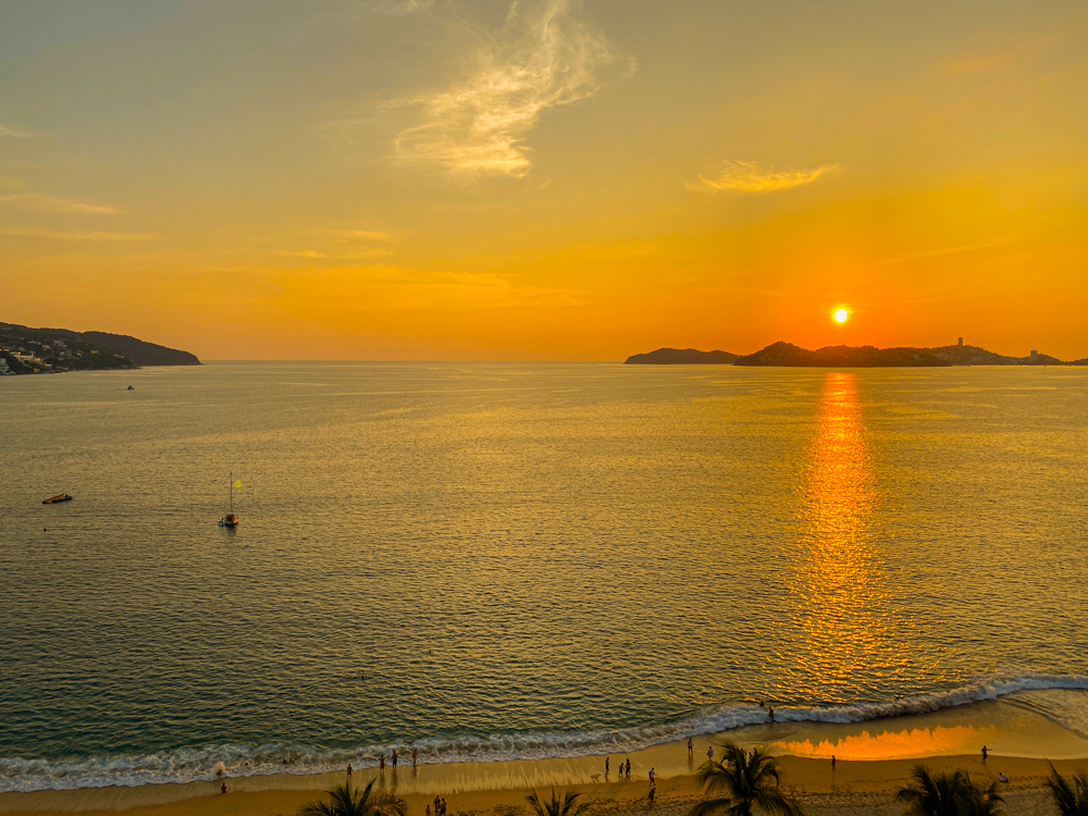 A beautiful orange and yellow sunset over the ocean in Acapulco, Mexico.