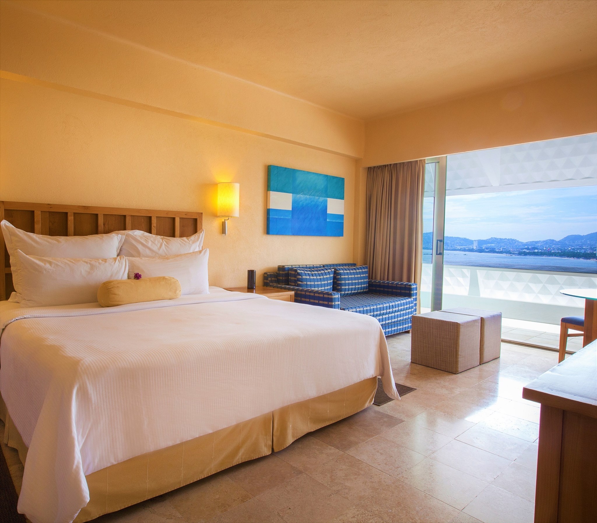 Bright beachfront resort with a large rectangular pool, shaded lounge areas, and sandy beach leading to turquoise waters; ideal for MICE groups, corporate meetings, incentive travel, beachfront networking and team-building activities in Acapulco.