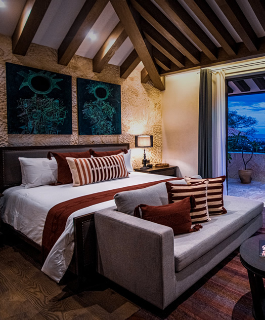 Rustic luxury suite in Oaxaca with mountain-view balcony, ideal for MICE guests seeking upscale accommodations during meetings and incentive travel programs.
