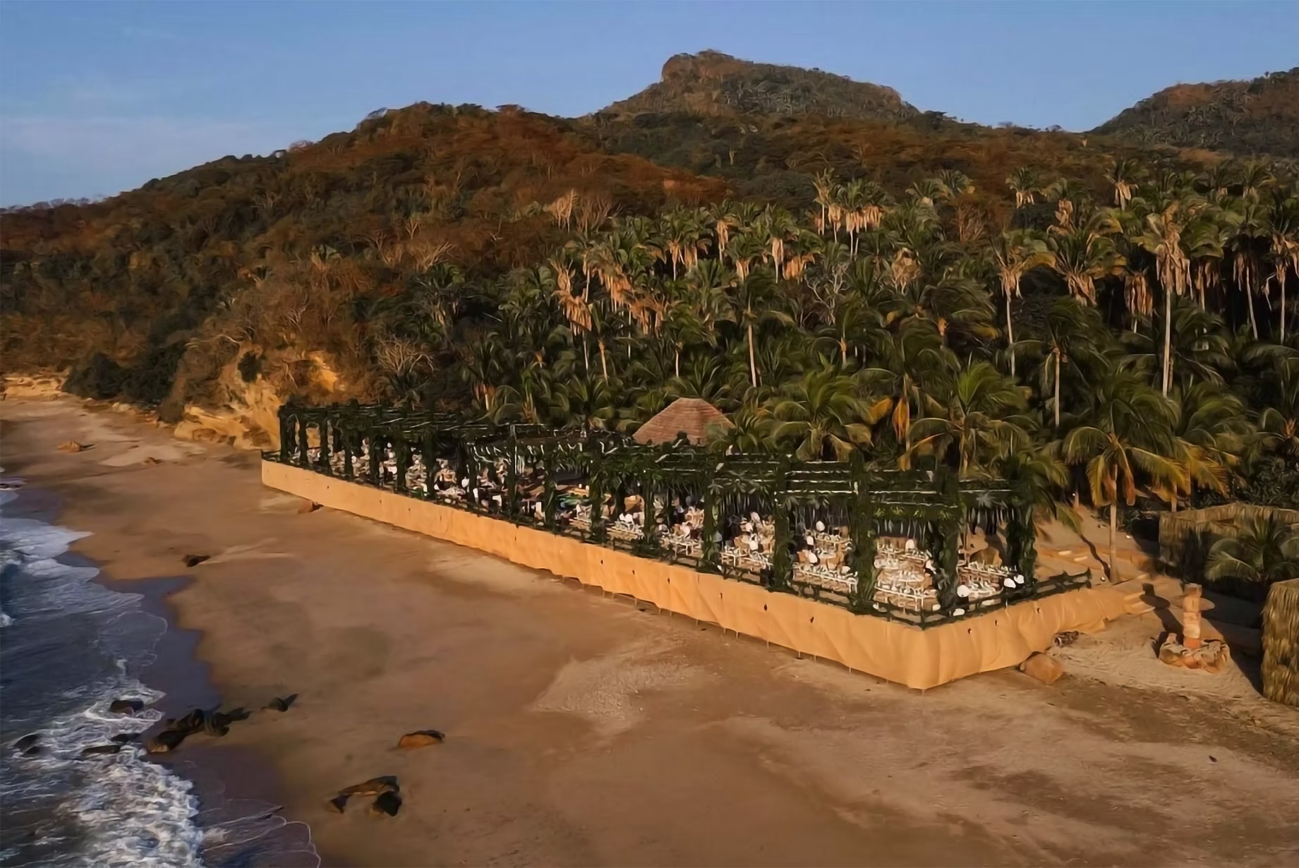 Elegant beachfront event setup at Imanta Resorts Punta de Mita, ideal for incentive travel, executive retreats, and luxury MICE programs in Mexico. Features formal dining layout under a pergola with tropical forest and ocean backdrop.