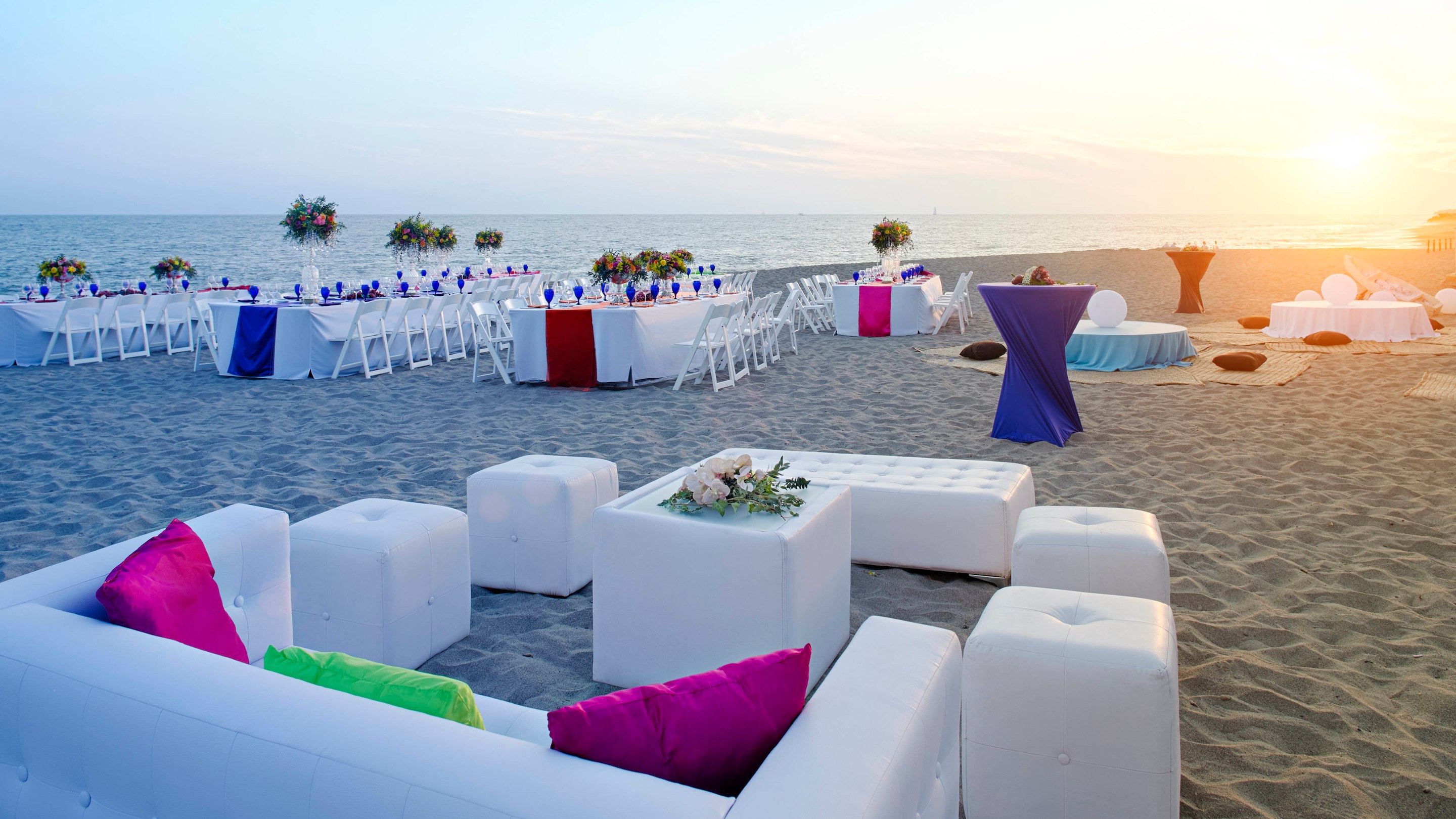 Beachfront event setup at Marriott Puerto Vallarta Resort & Spa during sunset, featuring lounge seating, banquet tables, and ocean views—ideal for incentive travel, corporate receptions, and MICE programs in Mexico