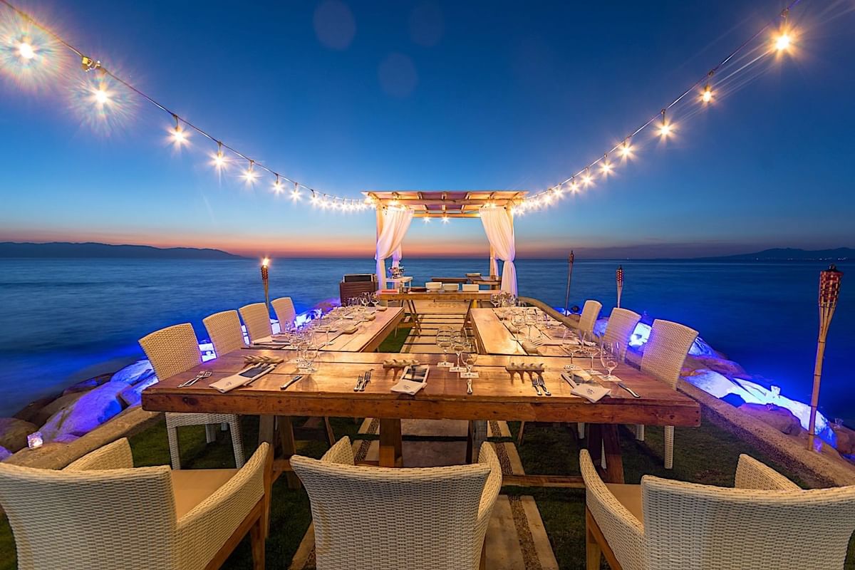 Elegant waterfront dining setup at Villa Premiere Boutique Hotel & Romantic Getaway in Puerto Vallarta, featuring sunset lighting, string lights, and formal table arrangement—ideal for incentive dinners, executive receptions, and boutique MICE events in Mexico.